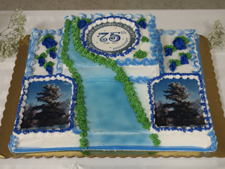 http://morrisoncountyhistory.org/museumpics/75thdinner_29.jpg The anniversary cake. We asked for pine trees and the river. The duplicate picture of the pines is actually of the large pine on our museum's property. MCHS 75th anniversary celebration, Royalton American Legion, September 18, 2011.
