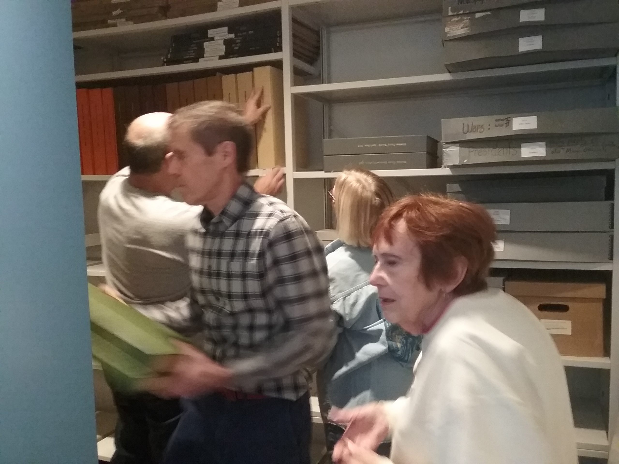 Peter, Cathy, Gary, and Pat putting newspapers on the new mobile shelving in the Archives at the Weyerhaeuser Museum, December 21, 2019.