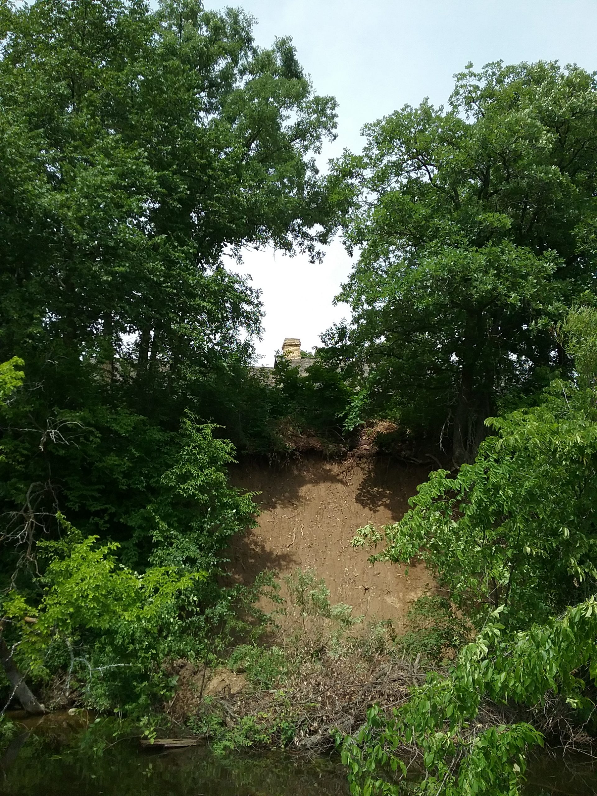 This shows the roof of the museum above the washout. It was taken from a pontoon on the river below the washout. Taken July 3, 2020.