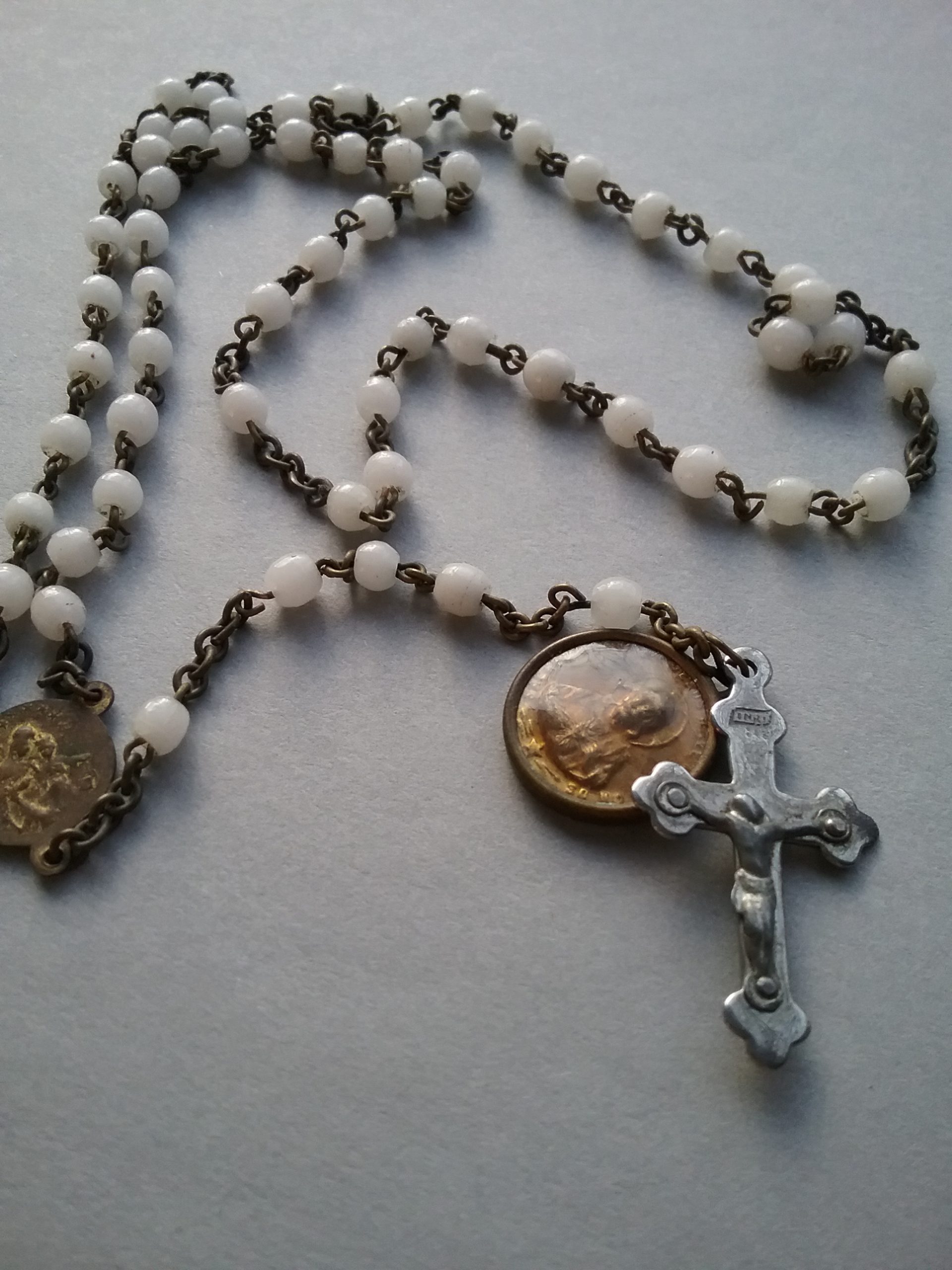 Catholic Rosary with white beads, featuring a medal. Donated by Stella LeBlanc. MCHS collections.