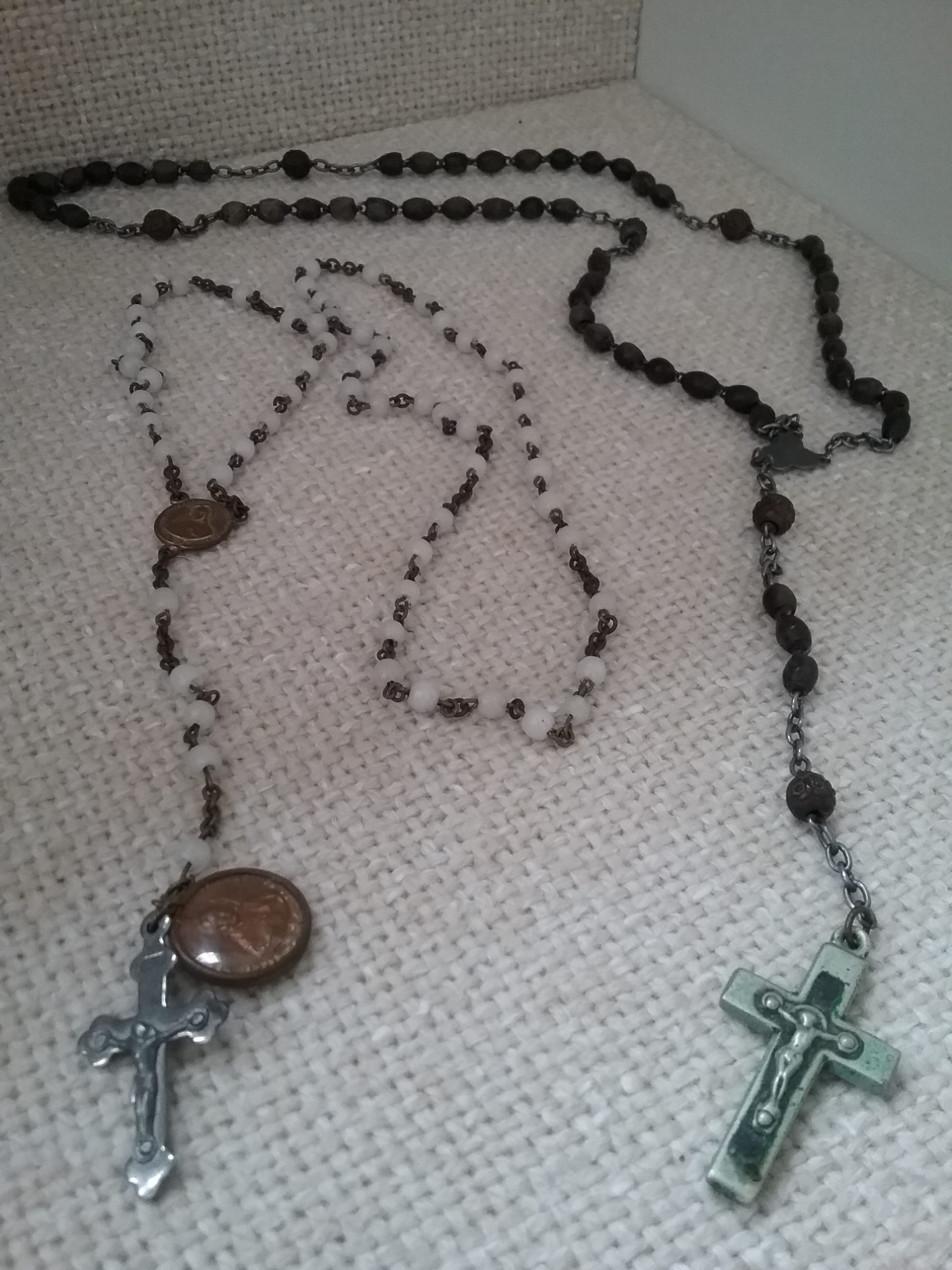 Catholic Rosaries, one with white beads, the other with black beads. Donated by Stella LeBlanc. MCHS collections.