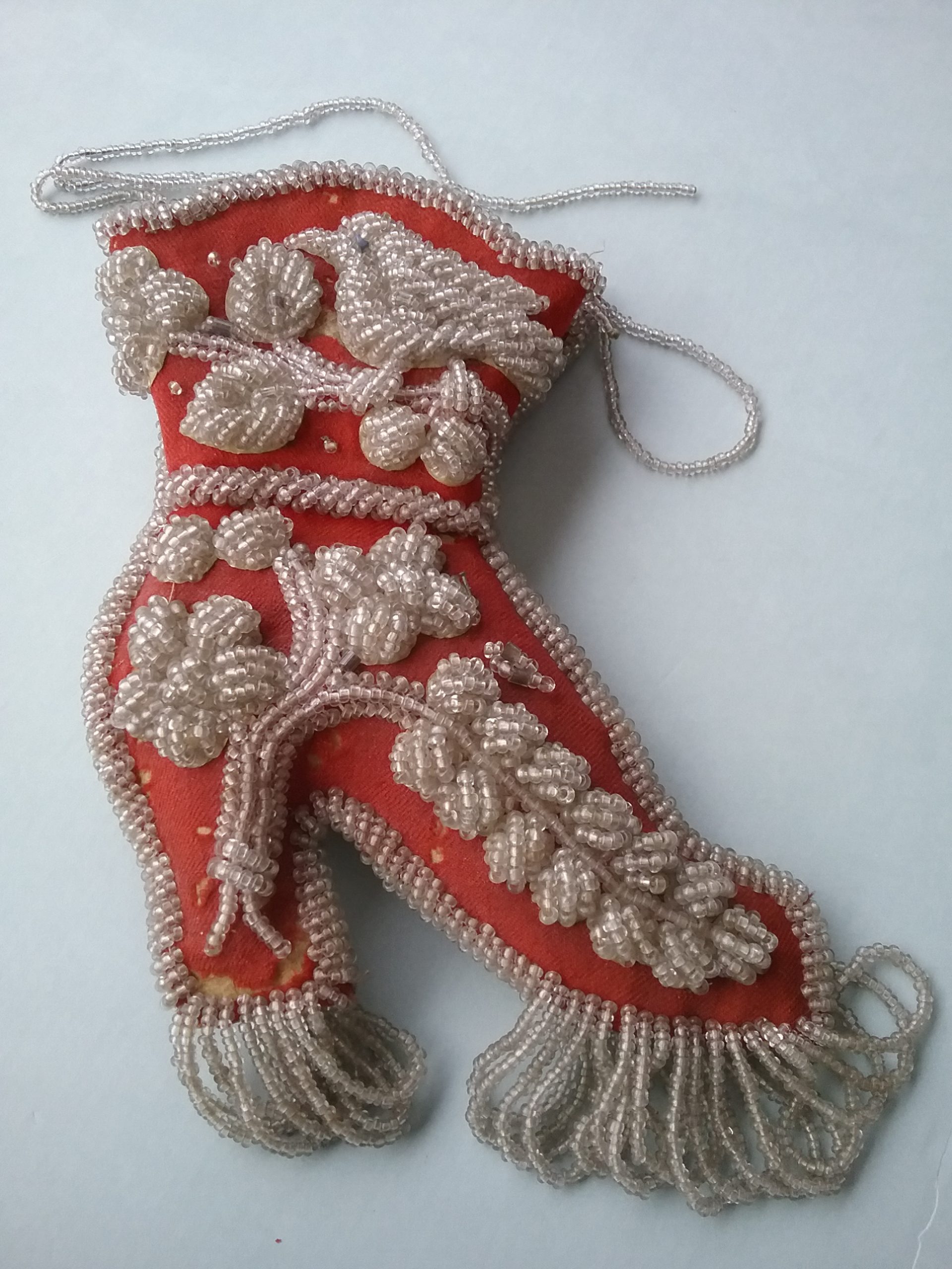 Small Red Beaded Shoe: This smaller red beaded shoe was also for decorative purposes, serving as a wall hanging. Donated by the Mrs. J.K. Martin estate. MCHS collections, #1971.10.103.