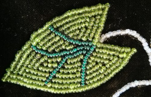 Beaded broad leaf arrowhead from an Ojibwe bandolier bag in the Weyerhaeuser Museum's collection.