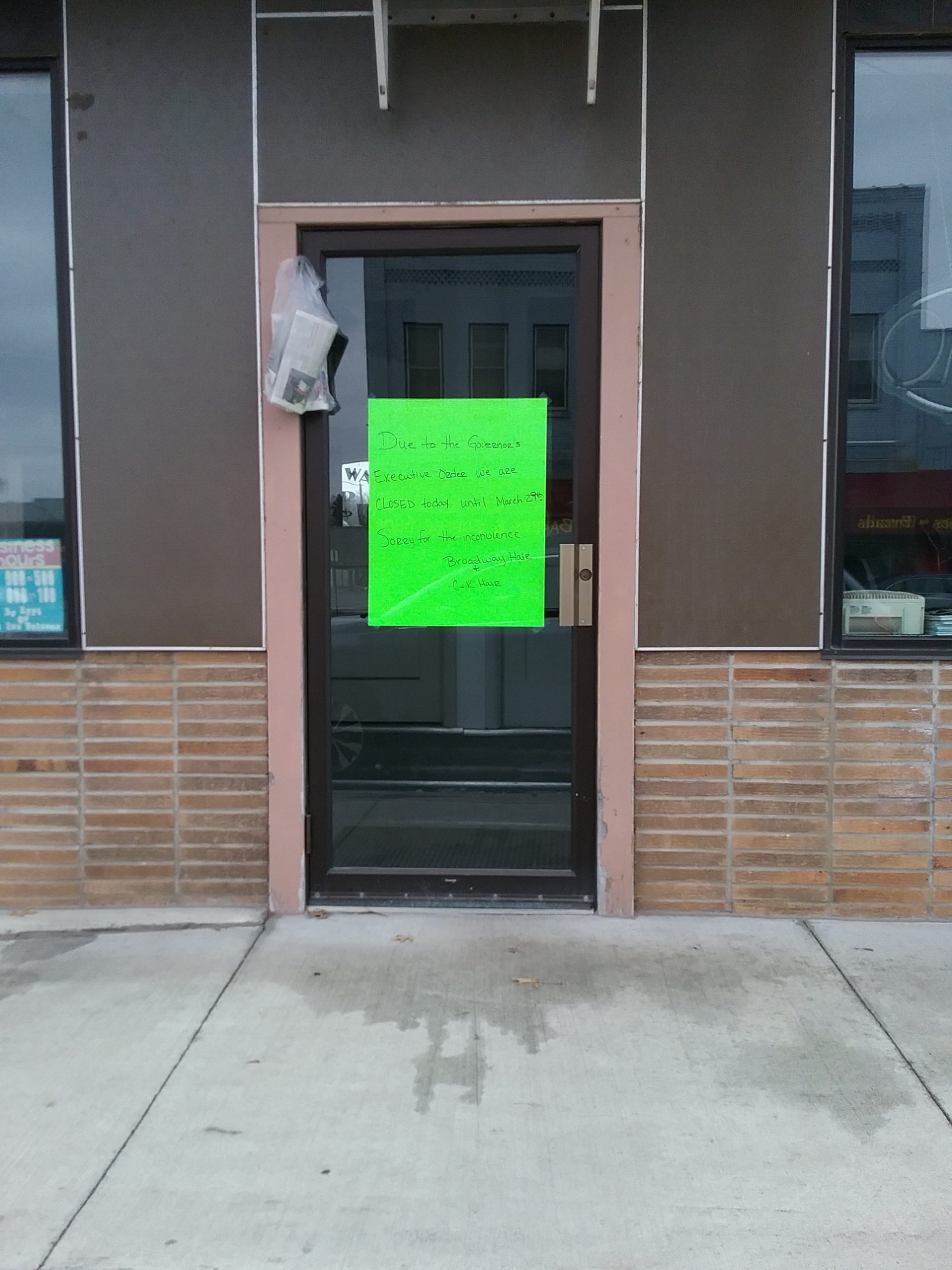Sign on Little Falls hair salon indicating the business is closed due to Governor Tim Walz's executive order during the COVID-19 pandemic, March 25, 2020.