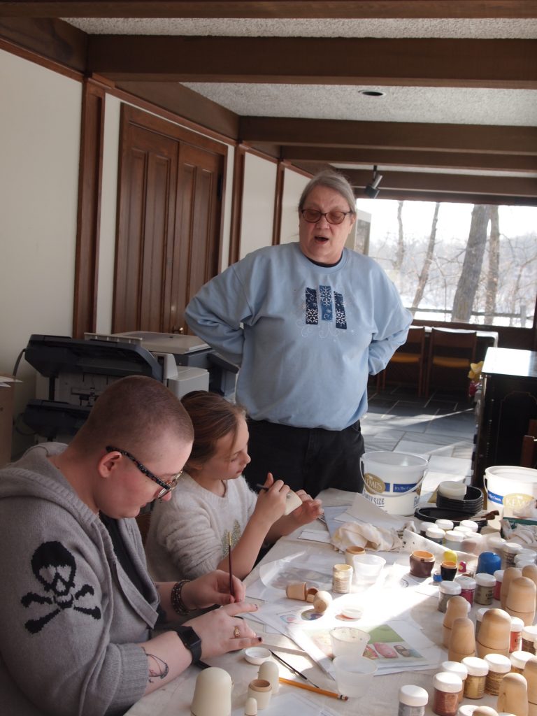 Kathy Gerdts-Senger (top) leading a Russian doll painting activity at The Charles A. Weyerhaeuser Memorial Museum in Little Falls, 2020.