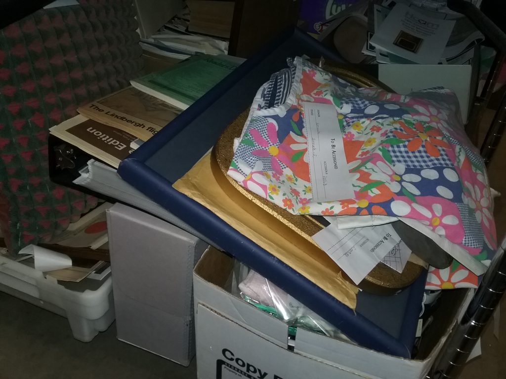 Collections-in-waiting at the Weyerhaeuser Museum, including documents, books, clothing, and 3-dimensional artifacts. August 5, 2021.