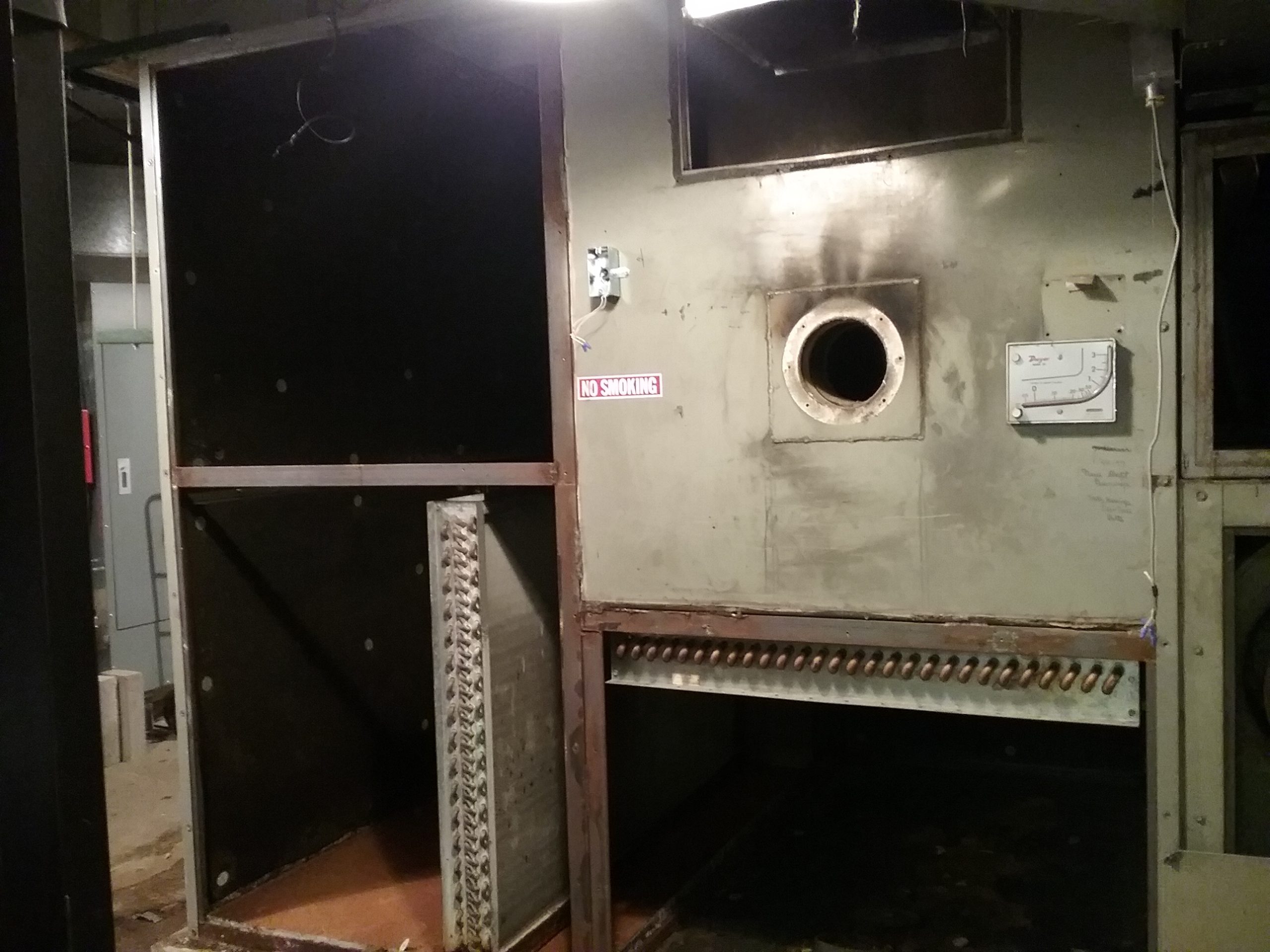 South side of the air handling unit with the control panel, humidifier, and side removed, exposing the large, dark cavities inside the air handler. Weyerhaeuser Museum, photo taken October 4, 2021.