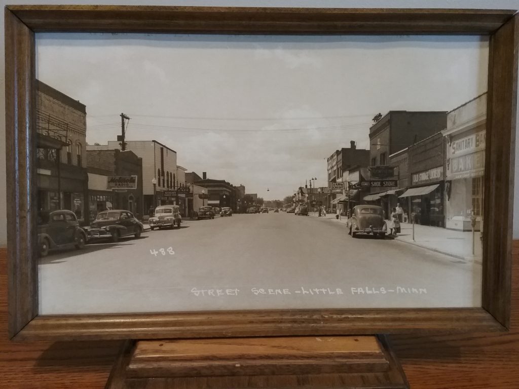 Framed, enlarged photo of East Broadway, downtown Little Falls, MN, c. 1948, donated by U.S. Bank.